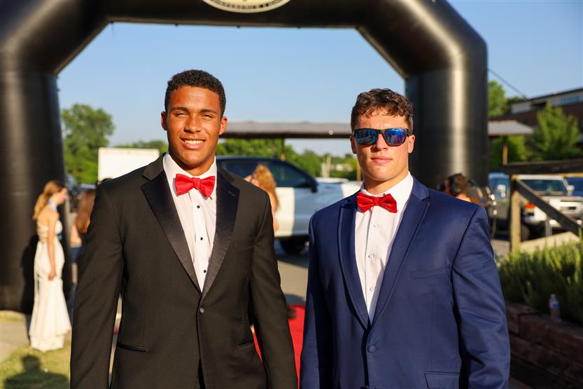 Student-athletes stand under an arch at the WILLCO Awards